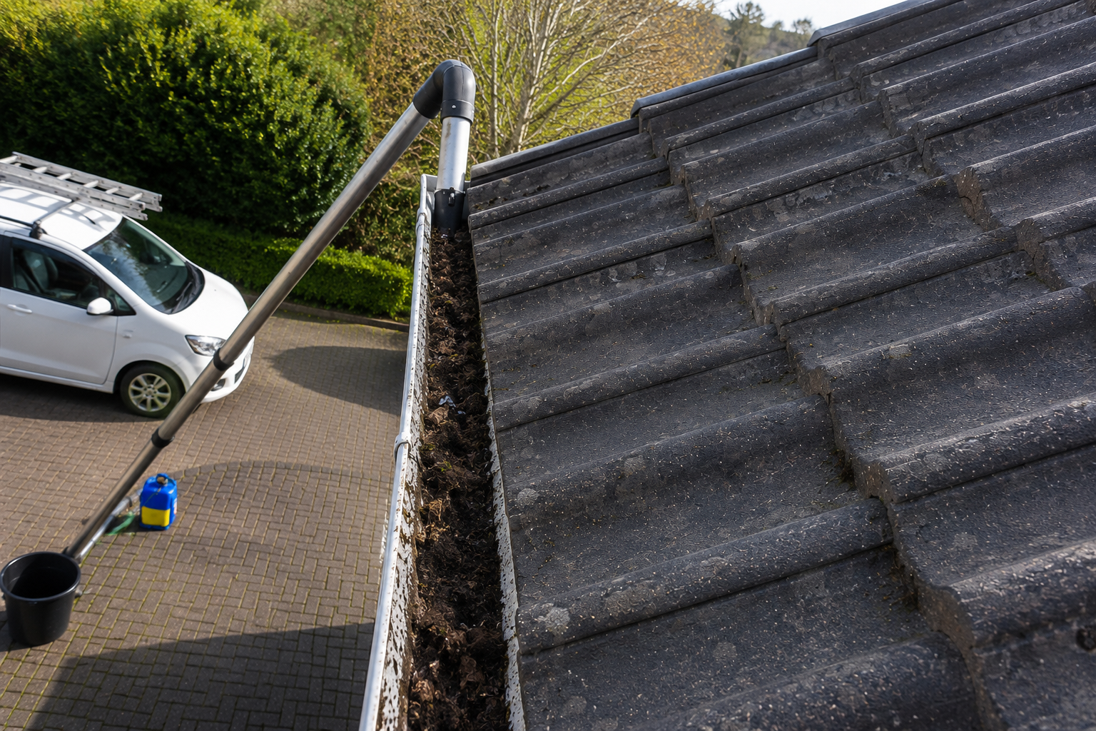 Before gutter cleaning Birmingham — blocked gutter with leaf and debris accumulation